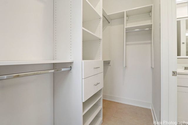 spacious closet featuring light tile patterned flooring