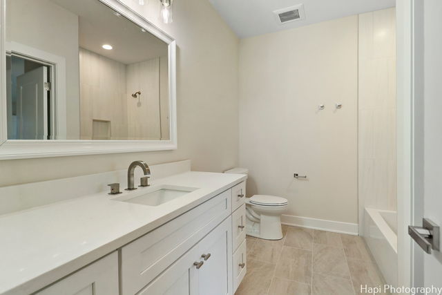 full bathroom with vanity,  shower combination, and toilet