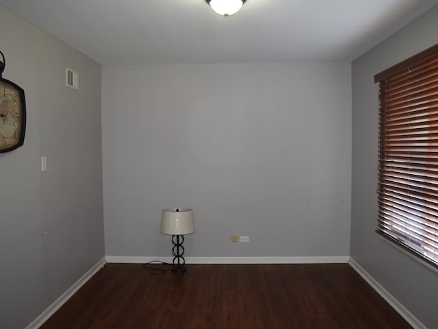 unfurnished room with dark hardwood / wood-style floors