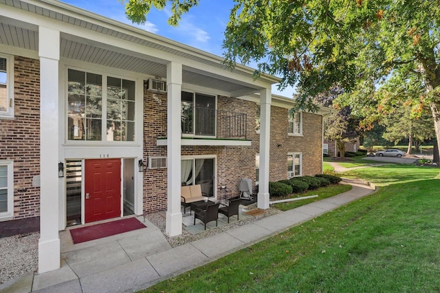 doorway to property with a lawn