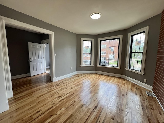 spare room with light hardwood / wood-style flooring