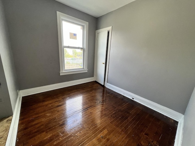 empty room featuring dark hardwood / wood-style flooring