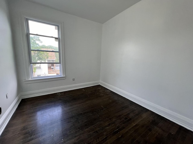 empty room featuring dark hardwood / wood-style flooring