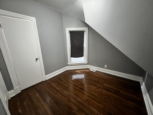 bonus room featuring wood-type flooring and vaulted ceiling