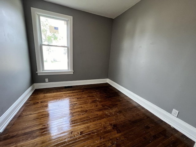 empty room featuring dark wood-type flooring