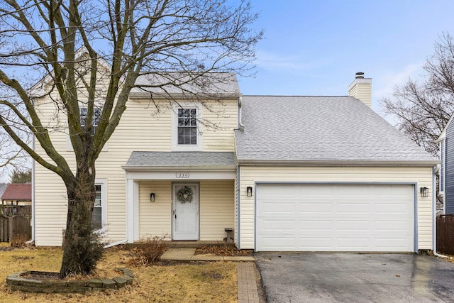 view of front of house featuring aphalt driveway, roof with shingles, a chimney, fence, and a garage