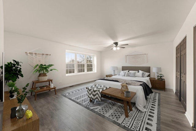 bedroom featuring ceiling fan, baseboards, and wood finished floors