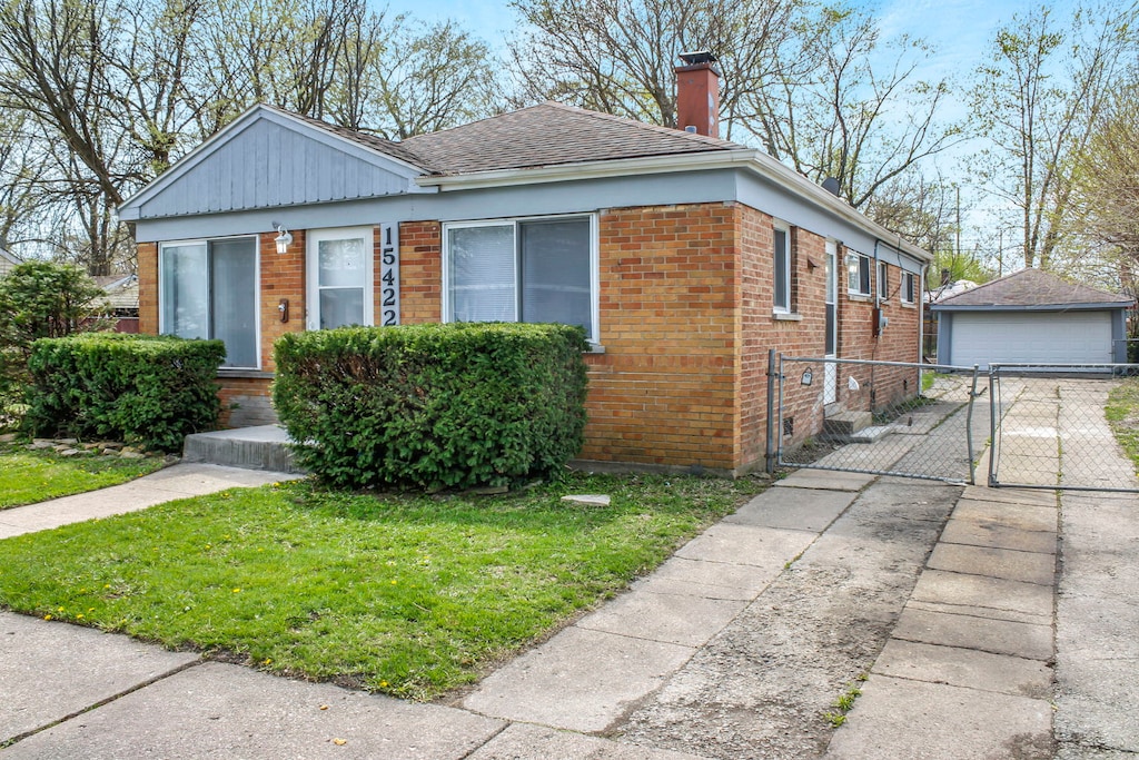 bungalow-style home with a front yard