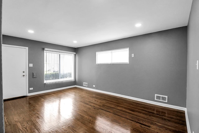 unfurnished room with dark hardwood / wood-style floors