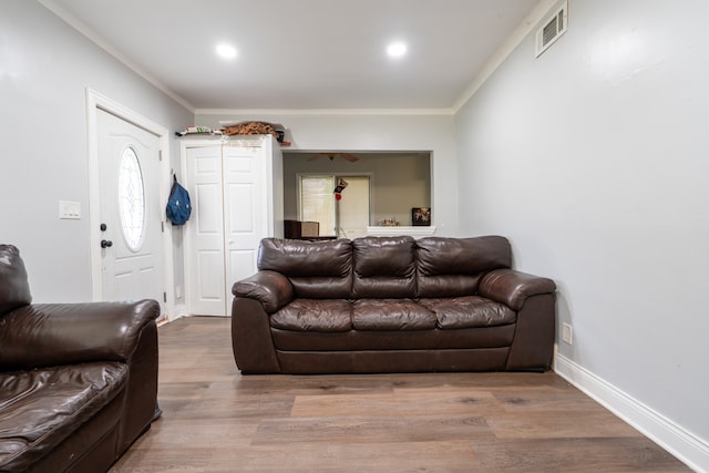 living room featuring crown molding and hardwood / wood-style floors