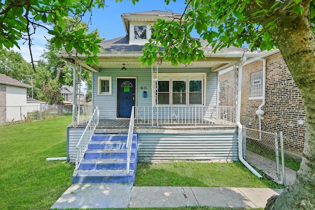 view of front of property featuring covered porch and a front yard