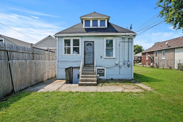 back of house featuring a yard