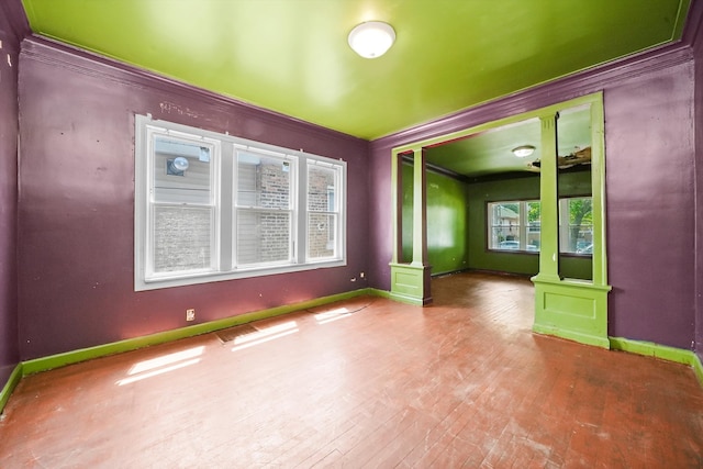 spare room featuring hardwood / wood-style floors and ornamental molding