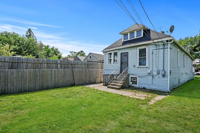 rear view of house with a lawn