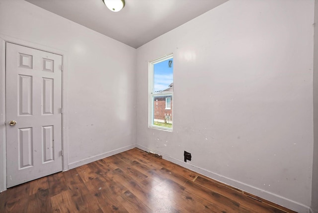 spare room with dark hardwood / wood-style floors