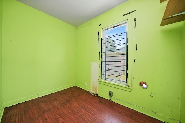 spare room with dark hardwood / wood-style flooring