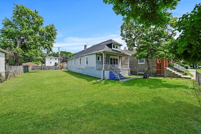 back of house featuring a yard