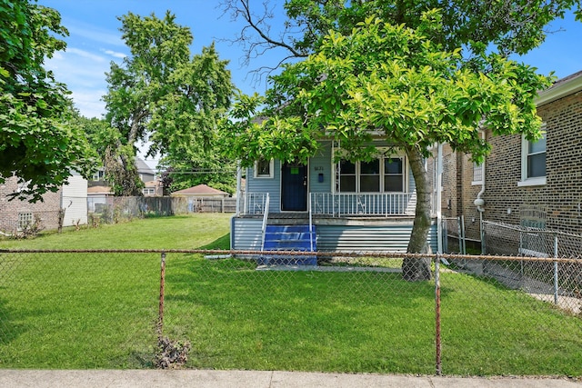 obstructed view of property featuring covered porch and a front lawn