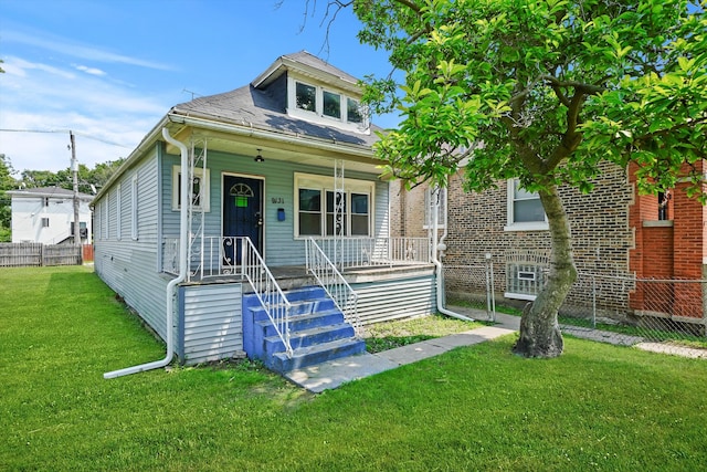 bungalow-style home with a front yard and covered porch