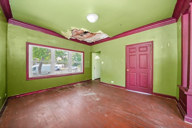 empty room featuring hardwood / wood-style floors and ornamental molding