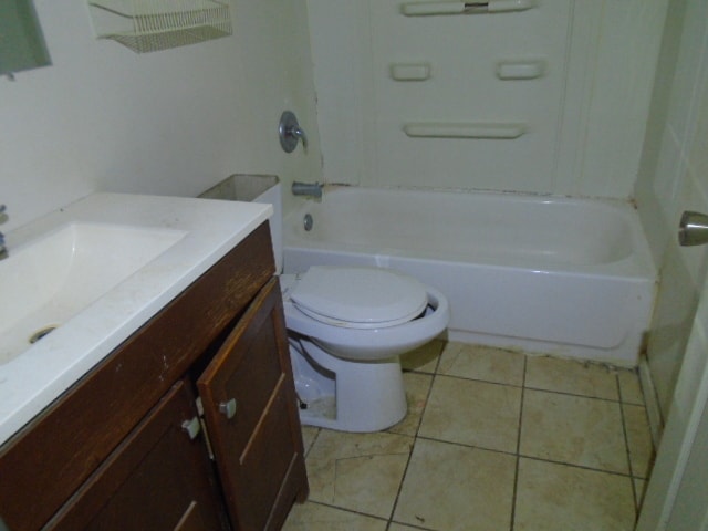 full bathroom with  shower combination, vanity, tile patterned flooring, and toilet