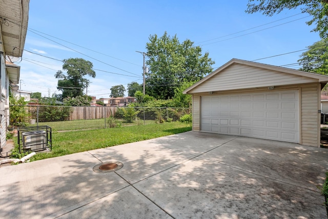 detached garage featuring fence