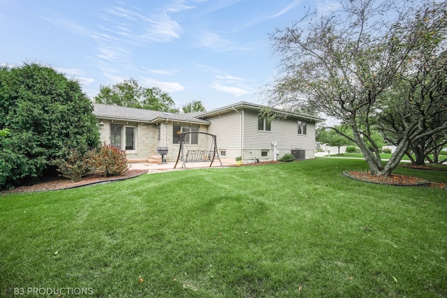 back of property featuring central AC, a patio area, and a lawn