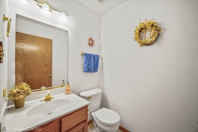 half bathroom with toilet and vanity