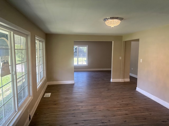 spare room with dark hardwood / wood-style flooring