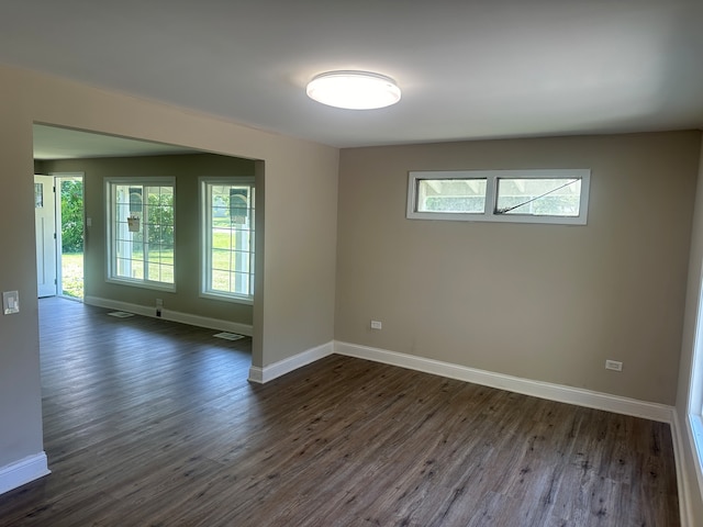 spare room with dark hardwood / wood-style flooring