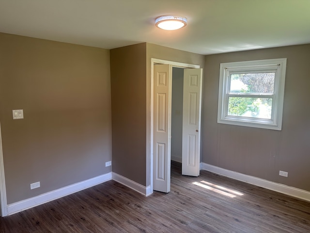 unfurnished bedroom with hardwood / wood-style floors and a closet