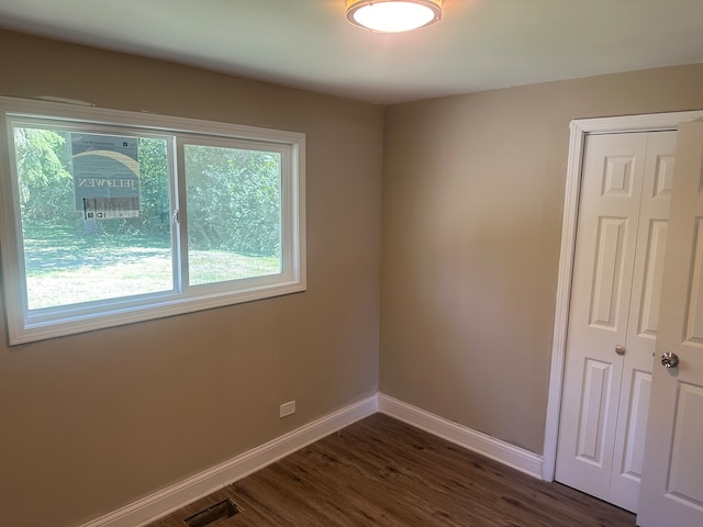 spare room with dark hardwood / wood-style floors