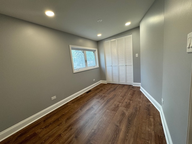 unfurnished bedroom featuring dark hardwood / wood-style floors