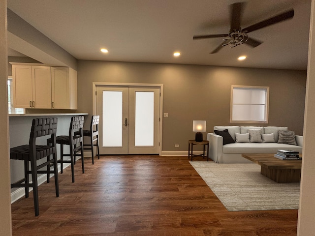 living room with hardwood / wood-style flooring, french doors, and ceiling fan