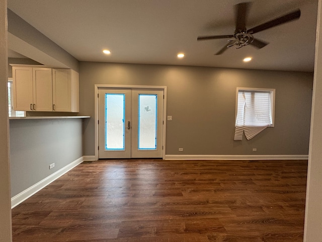 empty room featuring ceiling fan, hardwood / wood-style flooring, and french doors