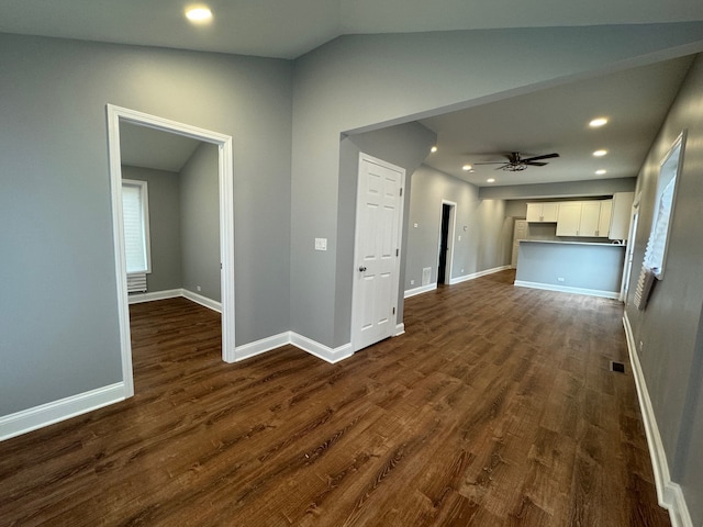 hallway featuring vaulted ceiling and dark hardwood / wood-style floors