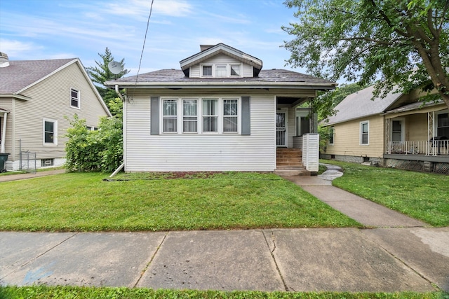 bungalow-style home featuring a front yard