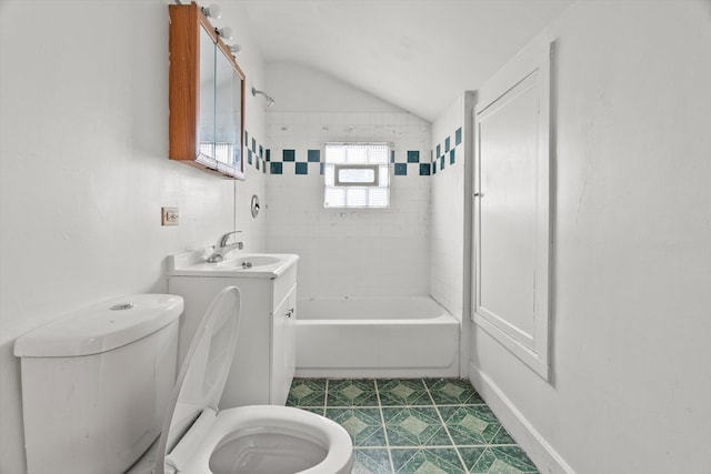 full bathroom featuring toilet, tile patterned floors, tiled shower / bath, and vaulted ceiling