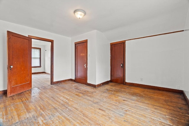 unfurnished room with light wood-type flooring