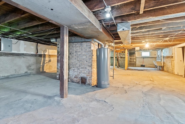 basement featuring sink, electric panel, and gas water heater