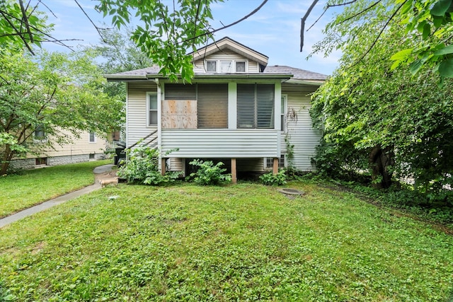 bungalow-style home featuring a front yard