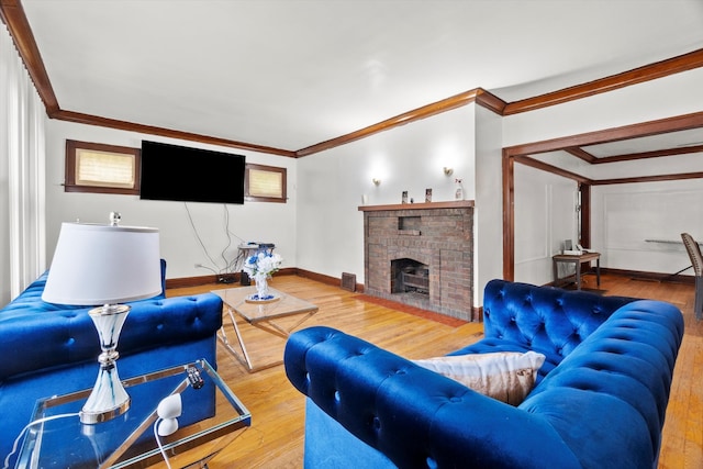 living room with ornamental molding, light hardwood / wood-style flooring, and a fireplace