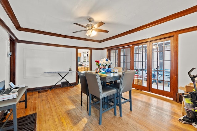 dining area featuring ceiling fan, light hardwood / wood-style flooring, ornamental molding, and french doors