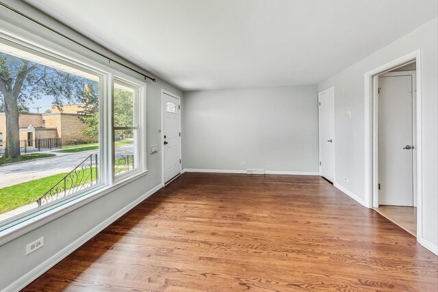 unfurnished room with hardwood / wood-style flooring