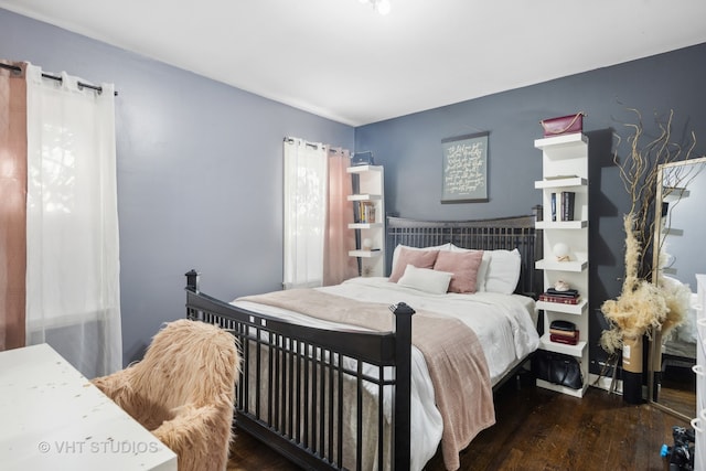 bedroom featuring dark hardwood / wood-style flooring