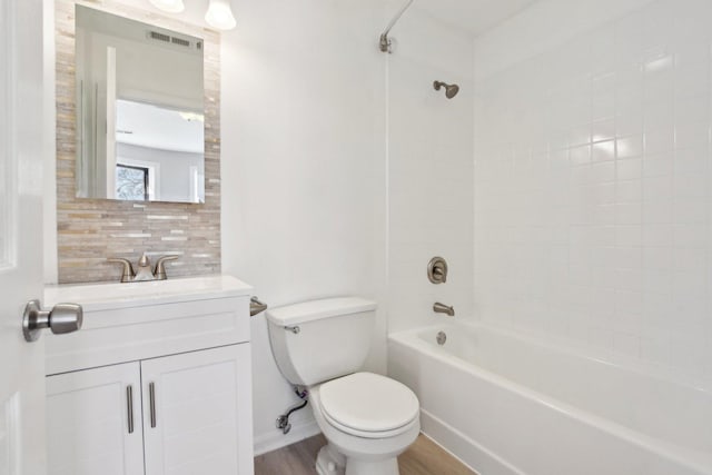 full bathroom featuring shower / washtub combination, backsplash, hardwood / wood-style flooring, vanity, and toilet