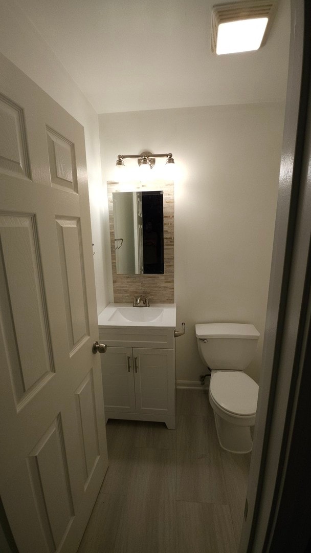 bathroom featuring toilet and vanity