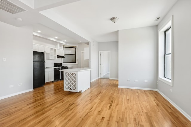 unfurnished living room with light wood-type flooring