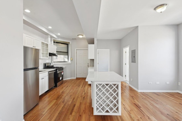 kitchen featuring appliances with stainless steel finishes, white cabinets, light hardwood / wood-style floors, and electric panel