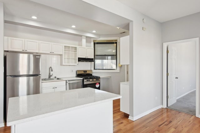 kitchen featuring light stone countertops, appliances with stainless steel finishes, sink, and white cabinets